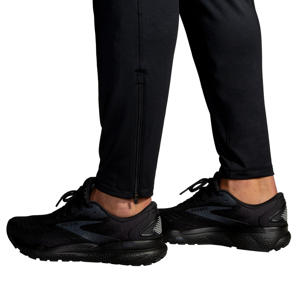 Men's Brooks Spartan Pants. Black. Ankle view.