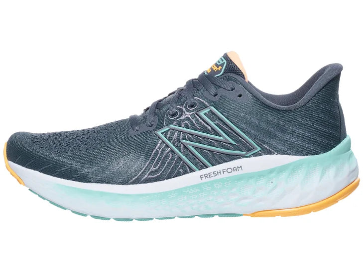 Men's New Balance Vongo V5. Grey upper. White/Green midsole. Lateral view.