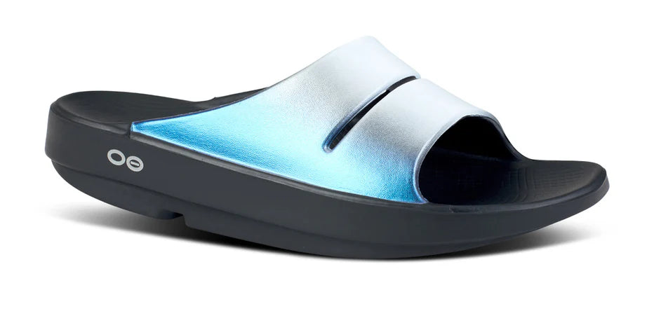 Women's Oofos Ooahh Luxe Slide. Light Blue upper. Black midsole. Lateral view.