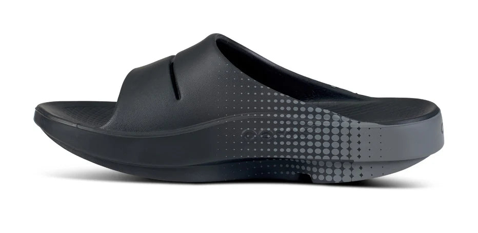 Oofos Ooahh Sport Slide. Black/Gray. Medial view.