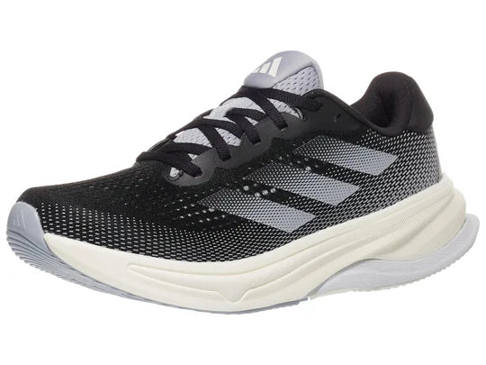 Women's Adidas Supernova Solution. Black upper. Off white midsole. Lateral view.