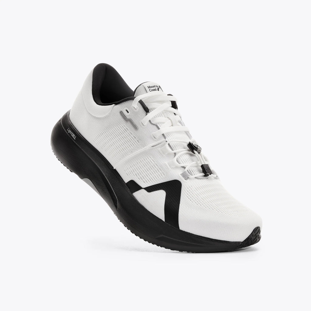 Women's Mount to Coast. R1. White upper. Black midsole. Lateral view.