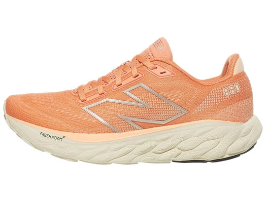 Women's New Balance 880 V14. Light Pink/Peach upper. Off white midsole. Lateral view.