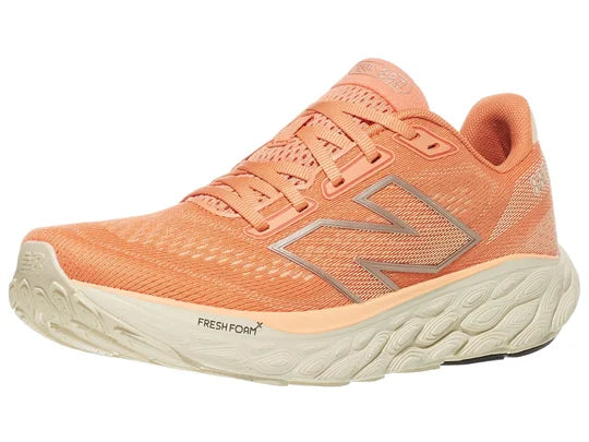 Women's New Balance 880 V14. Light Pink/Peach upper. Off white midsole. Lateral view.