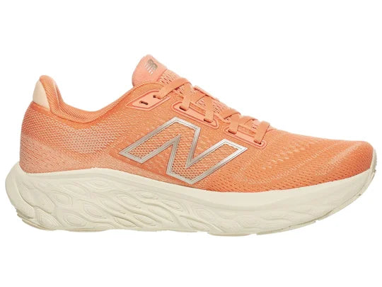 Women's New Balance 880 V14. Light Pink/Peach upper. Off white midsole. Medial view.