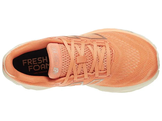 Women's New Balance 880 V14. Light Pink/Peach upper. Off white midsole. Top view.