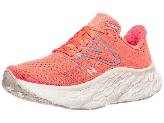 Women's New Balance More V4. Light Red upper. White midsole. Lateral view.