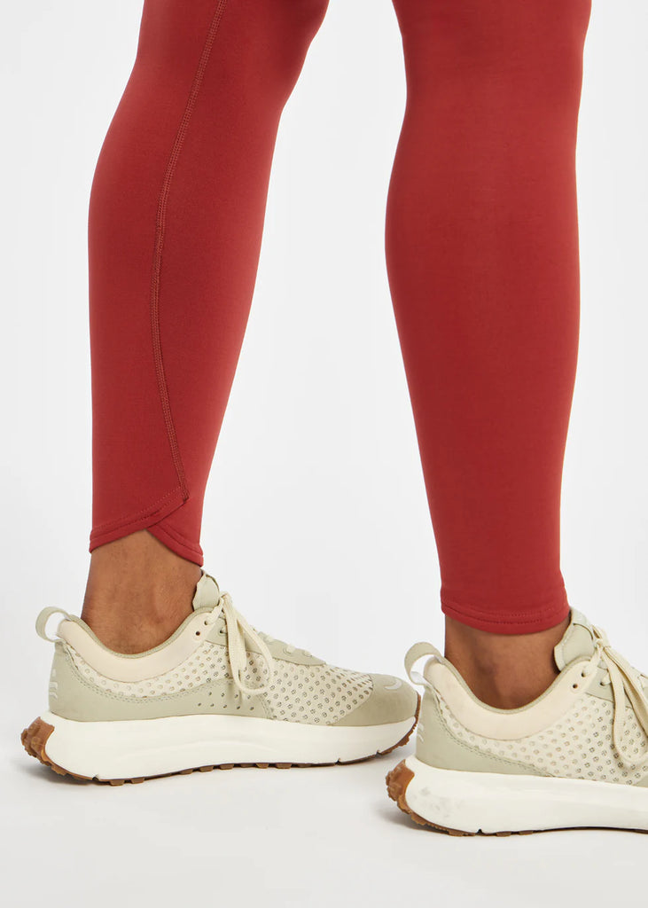 Women's Oiselle Flyout Tights. Red. Ankle closeup.