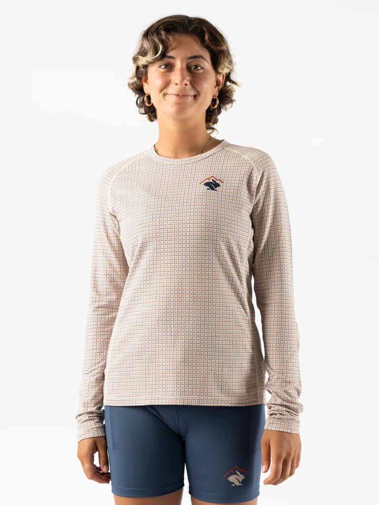 Women's rabbit layer one trail long sleeve. Light tan/plaid. Front view.