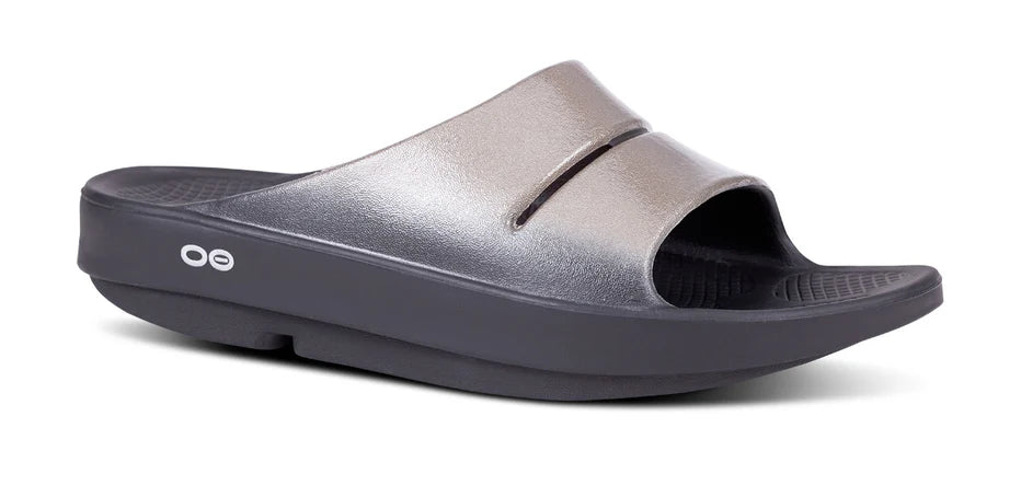 Oofos Ooahh Luxe Slide. Tan upper. Black midsole. Lateral view.