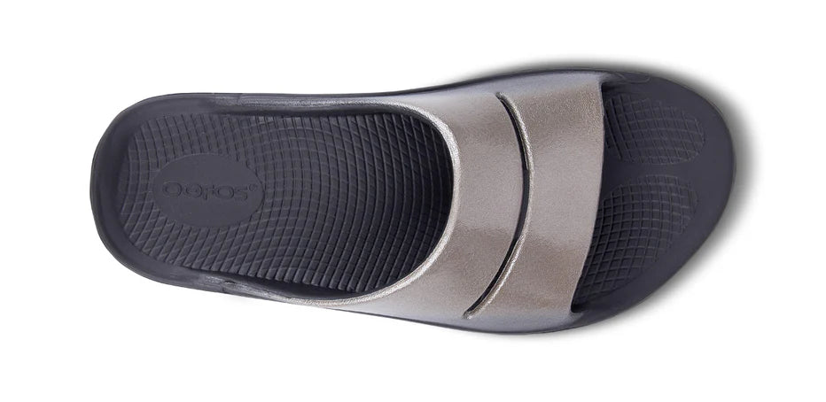 Oofos Ooahh Luxe Slide. Tan upper. Black midsole. Top view.