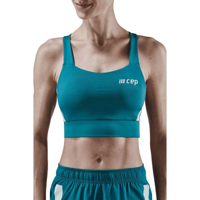Women's CEP Sports Bra. Teal. Front view.